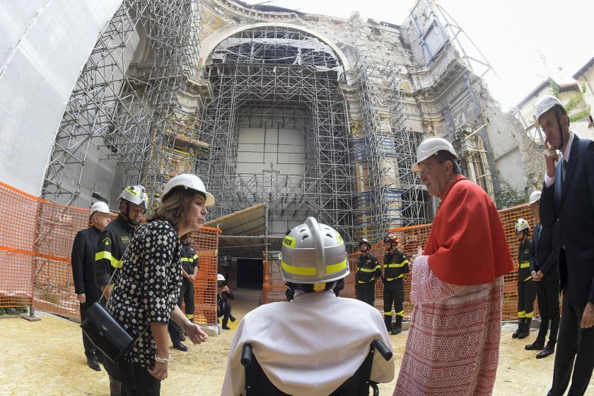 This photo taken and handout on August 28, 2022 by The Vatican Media shows Pope Francis (C), wearing a protective helmet from the Vigili del Fuoco, the Italian Firefighters Corps., escorted by Archbishop of l'Aquila, Italian Cardinal Giuseppe Petrocchi (R) as they hold a private visit of the Duomo cathedral in L'Aquila, on August 28, 2022 during a one-day pastoral visit to the 2009 earthquake-struck Abruzzo capital. Handout / VATICAN MEDIA This photo taken and handout on August 28, 2022 by The Vatican Media shows Pope Francis (C), wearing a protective helmet from the Vigili del Fuoco, the Italian Firefighters Corps., escorted by Archbishop of l'Aquila, Italian Cardinal Giuseppe Petrocchi (R) as they hold a private visit of the Duomo cathedral in L'Aquila, on August 28, 2022 during a one-day pastoral visit to the 2009 earthquake-struck Abruzzo capital. Handout / VATICAN MEDIA