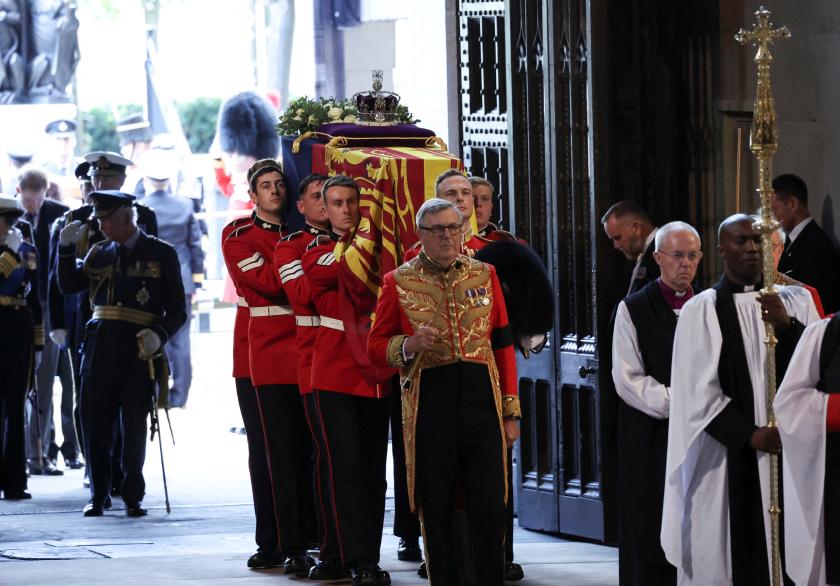 Pallbearers from The Queen's Company, 1st Battalion Grenadier Guards places the coffin of Britain's Queen Elizabeth II on a Catafalque inside Westminster Hall, at the Palace of Westminster, where she will Lie in State, in London on September 14, 2022. Queen Elizabeth II will lie in state in Westminster Hall inside the Palace of Westminster, from Wednesday until a few hours before her funeral on Monday, with huge queues expected to file past her coffin to pay their respects. Nariman El-Mofty / POOL / AFP Pallbearers from The Queen's Company, 1st Battalion Grenadier Guards places the coffin of Britain's Queen Elizabeth II on a Catafalque inside Westminster Hall, at the Palace of Westminster, where she will Lie in State, in London on September 14, 2022. Queen Elizabeth II will lie in state in Westminster Hall inside the Palace of Westminster, from Wednesday until a few hours before her funeral on Monday, with huge queues expected to file past her coffin to pay their respects. Nariman El-Mofty / POOL / AFP