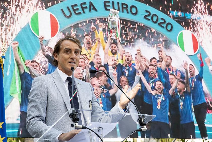 This photo taken and handout on July 12, 2021 by the press office of the Italian Presidential Quirinale Palace shows Italy's coach Roberto Mancini deliver a speech as players and staff of Italy's national football team attend a ceremony at the Quirinale palace in Rome, a day after Italy won the UEFA EURO 2020 final football match between Italy and England. Handout / Quirinale Press Office / AFP This photo taken and handout on July 12, 2021 by the press office of the Italian Presidential Quirinale Palace shows Italy's coach Roberto Mancini deliver a speech as players and staff of Italy's national football team attend a ceremony at the Quirinale palace in Rome, a day after Italy won the UEFA EURO 2020 final football match between Italy and England. Handout / Quirinale Press Office / AFP