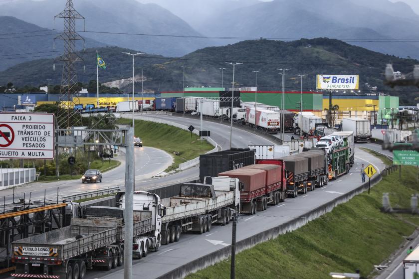 Supporters of President Jair Bolsonaro, mainly truck drivers, block the BR-101 highway in Palhoca, in the metropolitan region of Florianopolis, Santa Catarina State, Brazil, on October 31, 2022, as an apparent protest over Bolsonaro's defeat in the presidential run-off election. The transition period got off to a tense start as truckers and demonstrators blocked several highways across Brazil on Monday in an apparent protest over the electoral defeat of Bolsonaro to leftist Luiz Inacio Lula da Silva, burning tyres and parking vehicles in the middle of the road to halt traffic. Anderson Coelho / AFP Supporters of President Jair Bolsonaro, mainly truck drivers, block the BR-101 highway in Palhoca, in the metropolitan region of Florianopolis, Santa Catarina State, Brazil, on October 31, 2022, as an apparent protest over Bolsonaro's defeat in the presidential run-off election. The transition period got off to a tense start as truckers and demonstrators blocked several highways across Brazil on Monday in an apparent protest over the electoral defeat of Bolsonaro to leftist Luiz Inacio Lula da Silva, burnin