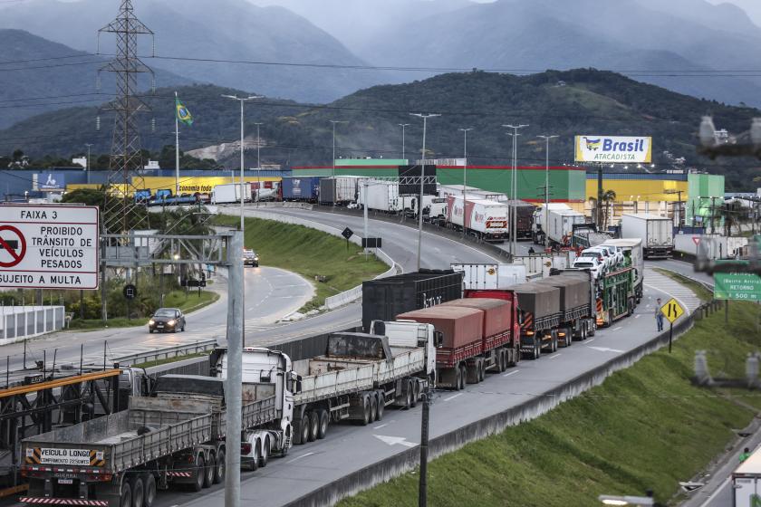 Supporters of President Jair Bolsonaro, mainly truck drivers, block the BR-101 highway in Palhoca, in the metropolitan region of Florianopolis, Santa Catarina State, Brazil, on October 31, 2022, as an apparent protest over Bolsonaro's defeat in the presidential run-off election. The transition period got off to a tense start as truckers and demonstrators blocked several highways across Brazil on Monday in an apparent protest over the electoral defeat of Bolsonaro to leftist Luiz Inacio Lula da Silva, burnin