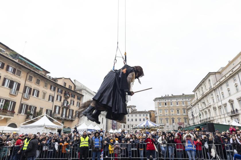A 'Befana' hangs from a fire engine's ladder as she flies above a crowd of people gathering for traditional Epiphany celebration in Piazza Navona in Rome, Italy, 06 January 2023. A 'Befana' hangs from a fire engine's ladder as she flies above a crowd of people gathering for traditional Epiphany celebration in Piazza Navona in Rome, Italy, 06 January 2023.