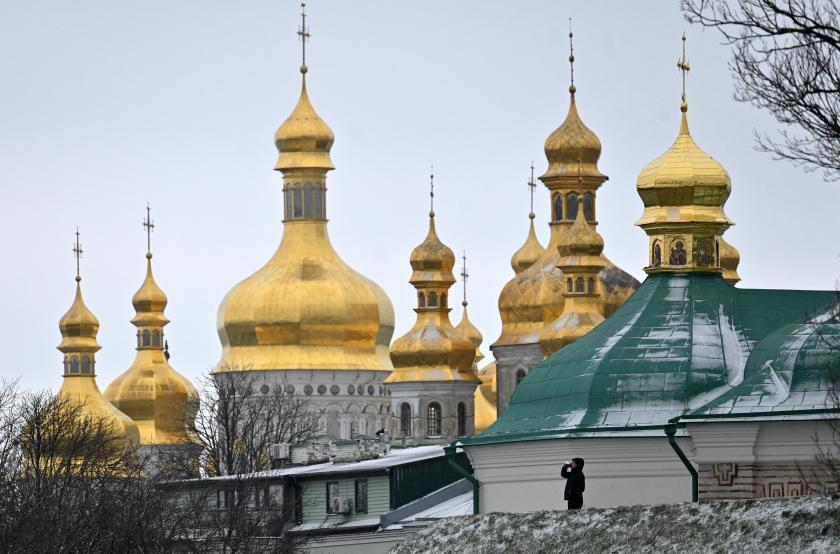 A man drinks a beverage in front of the Kyiv-Pechersk Lavra in the Ukrainian capital of Kyiv during the Orthodox Christmas Eve, on January 6, 2023. Sergei SUPINSKY / AFP A man drinks a beverage in front of the Kyiv-Pechersk Lavra in the Ukrainian capital of Kyiv during the Orthodox Christmas Eve, on January 6, 2023. Sergei SUPINSKY / AFP