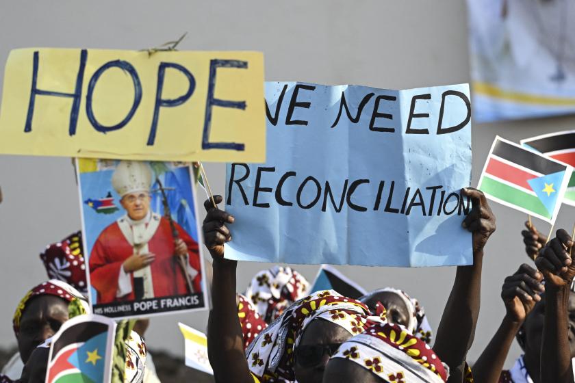 An attendee holds a poster with the message "We Need Reconciliation" on ahead of Pope Francis' meeting with bishops, priests, deacons, consecrated persons and seminarians at the Cathedral of Saint Therese in Juba, South Sudan, on February 4, 2023. Pope Francis will meet South Sudan's religious leaders, who work with the poor and marginalised and are deeply respected in the devout country where 60 percent of its 12 million people are Christian. Tiziana FABI / AFP An attendee holds a poster with the message "We Need Reconciliation" on ahead of Pope Francis' meeting with bishops, priests, deacons, consecrated persons and seminarians at the Cathedral of Saint Therese in Juba, South Sudan, on February 4, 2023. Pope Francis will meet South Sudan's religious leaders, who work with the poor and marginalised and are deeply respected in the devout country where 60 percent of its 12 million people are Christian. Tiziana FABI / AFP