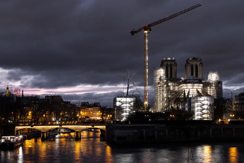 This photograph taken on February 17, 2023 in Paris, shows the Eiffel Tower (L) and Notre-Dame Cathedral covered in scaffolding, illuminated at night, as reconstruction work takes place since the blaze of April 15, 2019. JOEL SAGET / AFP This photograph taken on February 17, 2023 in Paris, shows the Eiffel Tower (L) and Notre-Dame Cathedral covered in scaffolding, illuminated at night, as reconstruction work takes place since the blaze of April 15, 2019. JOEL SAGET / AFP