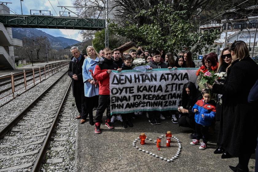 Members of the public hold a banner reading "I was not an accident or bad timing, it is the money above human life" at the railway station of Rapsani, north Greece, on March 5, 2023, during a commemorative gathering for the victims of a deadly train crash which killed 57. Students and residents of the municipality of Tempi, gathered in the valley of Tempi in memory of the victims of Greece's worst rail disaster, which occured in nearby Larissa on February 28. Many of the victims were students who were returning from a weekend break. Sakis MITROLIDIS / AFP Members of the public hold a banner reading "I was not an accident or bad timing, it is the money above human life" at the railway station of Rapsani, north Greece, on March 5, 2023, during a commemorative gathering for the victims of a deadly train crash which killed 57. Students and residents of the municipality of Tempi, gathered in the valley of Tempi in memory of the victims of Greece's worst rail disaster, which occured in nearby Larissa on February 28. Many of the victims were students who were retur
