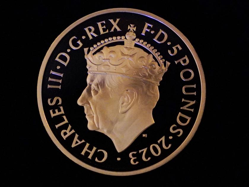A picture shows the first struck £5 Coronation coin, which was presented to Britain's King Charles III at Windsor Castle, west of London on April 13, 2023. A crowned portrait of the King will for the first time feature on a new range of commemorative coins created to celebrate the upcoming coronation. The collection, which includes a 50p and £5 coin, will be released later this month ahead of the historic May 6 celebration. Jonathan Brady / POOL / AFP A picture shows the first struck £5 Coronation coin, which was presented to Britain's King Charles III at Windsor Castle, west of London on April 13, 2023. A crowned portrait of the King will for the first time feature on a new range of commemorative coins created to celebrate the upcoming coronation. The collection, which includes a 50p and £5 coin, will be released later this month ahead of the historic May 6 celebration. Jonathan Brady / POOL / AFP