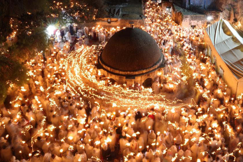 Ethiopian Orthodox Christian pilgrims hold candles during a ceremony of the "Holy Fire" at the Deir Al-Sultan Monastery on the roof of the Holy Sepulchre Church in Jerusalem's Old City on April 15, 2023, on the eve of Orthodox Easter. AHMAD GHARABLI / AFP Ethiopian Orthodox Christian pilgrims hold candles during a ceremony of the "Holy Fire" at the Deir Al-Sultan Monastery on the roof of the Holy Sepulchre Church in Jerusalem's Old City on April 15, 2023, on the eve of Orthodox Easter. AHMAD GHARABLI / AFP