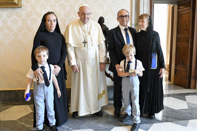 This handout photo taken and released on June 30, 2023, by The Vatican Media shows Pope Francis (2ndL) posing with Stella Assange (L), wife of WikiLeaks founder Julian Assange, and her children, during a private audience in the Vatican. Handout / VATICAN MEDIA / AFP