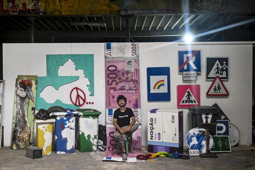 Portuguese artist Artur Bordalo, who goes by the artistic name of Bordalo II, poses at his studio in Lisbon on July 28, 2023. Portuguese artist Bordalo II reignited controversy over the costs of World Youth Day (WYD) global gathering of young Catholics, to be held in early August in Lisbon, after unrolling a carpet representing 500 euro banknotes on the stage which will host the closing mass. Patricia DE MELO MOREIRA / AFP Portuguese artist Artur Bordalo, who goes by the artistic name of Bordalo II, poses at his studio in Lisbon on July 28, 2023. Portuguese artist Bordalo II reignited controversy over the costs of World Youth Day (WYD) global gathering of young Catholics, to be held in early August in Lisbon, after unrolling a carpet representing 500 euro banknotes on the stage which will host the closing mass. Patricia DE MELO MOREIRA / AFP