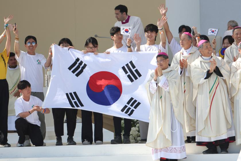 Pilgrims and bishops celebrate on stage holding a South Korean flag, as the next WYD are to be held in Seoul, during the closing mass of the World Youth Days (WYD) in Tejo Park, Lisbon, on August 6, 2023. Around one million pilgrims from all over the world will attend the World Youth Day, the largest Catholic gathering in the world, created in 1986 by John Paul II. Thomas COEX / AFP Pilgrims and bishops celebrate on stage holding a South Korean flag, as the next WYD are to be held in Seoul, during the closing mass of the World Youth Days (WYD) in Tejo Park, Lisbon, on August 6, 2023. Around one million pilgrims from all over the world will attend the World Youth Day, the largest Catholic gathering in the world, created in 1986 by John Paul II. Thomas COEX / AFP