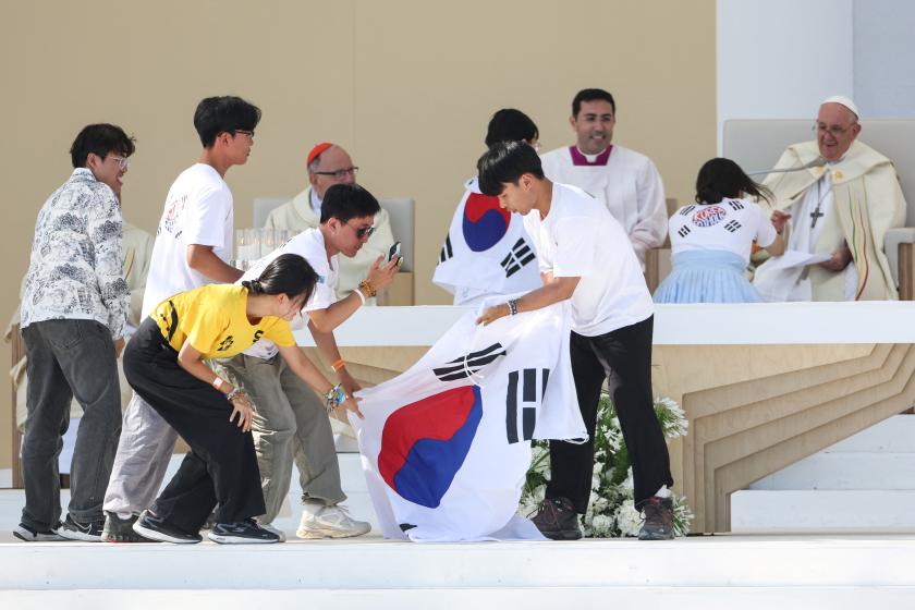 Pope Francis gestures while pilgrims celebrate on stage holding a South Korean flag, as the next WYD are to be held in Seoul, during the closing mass of the World Youth Days (WYD) in Tejo Park, Lisbon, on August 6, 2023. Around one million pilgrims from all over the world will attend the World Youth Day, the largest Catholic gathering in the world, created in 1986 by John Paul II. Pope Francis gestures while pilgrims celebrate on stage holding a South Korean flag, as the next WYD are to be held in Seoul, during the closing mass of the World Youth Days (WYD) in Tejo Park, Lisbon, on August 6, 2023. Around one million pilgrims from all over the world will attend the World Youth Day, the largest Catholic gathering in the world, created in 1986 by John Paul II.