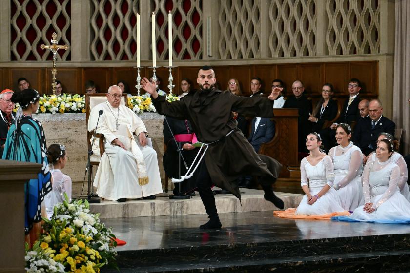 A dancer performs during a meeting of Pope Francis (L) with members of the Catholic community a the Notre-Dame Cathedral in Luxembourg City, on September 26, 2024. The pope is on a four-day apostolic journey to Luxembourg and Belgium. Alberto PIZZOLI / AFP A dancer performs during a meeting of Pope Francis (L) with members of the Catholic community a the Notre-Dame Cathedral in Luxembourg City, on September 26, 2024. The pope is on a four-day apostolic journey to Luxembourg and Belgium. Alberto PIZZOLI / AFP