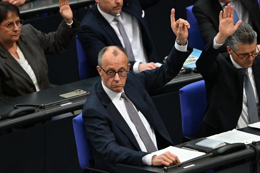 Friedrich Merz (C), leader of Germany's conservative Christian Democratic Union (CDU) party, and the CDU's parliamentary managing director Thorsten Frei raise their hands during a vote at a session of the Bundestag (lower house of parliament) on March 18, 2025 in Berlin, Germany. The German parliament on voted for a colossal defence and infrastructure spending package proposed by chancellor-in-waiting Friedrich Merz amid concern over the US stance on the Ukraine war and Europe's security. RALF HIRSCHBERGER / AFP Friedrich Merz (C), leader of Germany's conservative Christian Democratic Union (CDU) party, and the CDU's parliamentary managing director Thorsten Frei raise their hands during a vote at a session of the Bundestag (lower house of parliament) on March 18, 2025 in Berlin, Germany. The German parliament on voted for a colossal defence and infrastructure spending package proposed by chancellor-in-waiting Friedrich Merz amid concern over the US stance on the Ukraine war and Europe's security. RALF HIRSCHBERGER