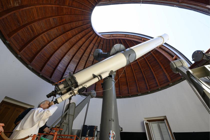 This handout photo taken and released on July 20, 2025 by the Vatican press office, Vatican Media shows Pope Leo XIV looking through a telescope during his visit at the Vatican Observatory, Specola in the summer papal estate in Castel Gandolfo, 40 km southeast of Rome. This handout photo taken and released on July 20, 2025 by the Vatican press office, Vatican Media shows Pope Leo XIV looking through a telescope during his visit at the Vatican Observatory, Specola in the summer papal estate in Castel Gandolfo, 40 km southeast of Rome.