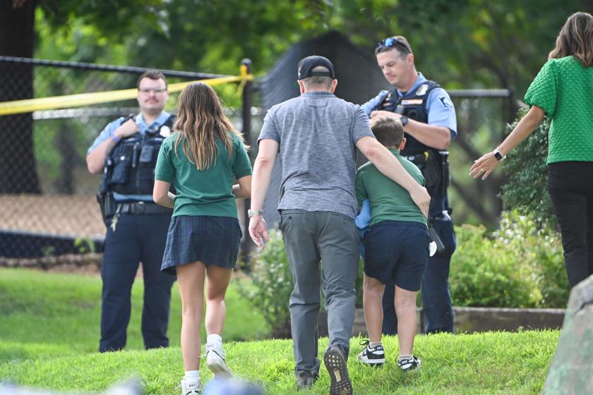 An adult and child take a moment while they leave the school as police respond to a shooting at the Annunciation Catholic School in Minneapolis, Minnesota, USA, 27 August 2025. According to police, two children and the gunman died and several were injured in the shooting at a Catholic primary church. EPA/CRAIG LASSIG