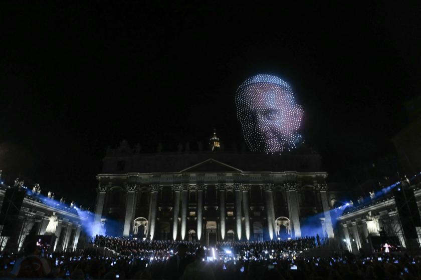 People watch as a portrait of Pope Francis is created with drones during "Grace for the World" free concert and light show in Saint Peter's Square at the Vatican on September 13, 2025. "Grace for the World" concert is co-directed by American songwriter Pharrell Williams and Italian tenor Andrea Bocelli. The event marks the end of the third "World Meeting on Human Fraternity", a series of encounters launched after the 2020 publication of the "All Brothers" encyclical by the late pope Francis. Filippo MONTEFO