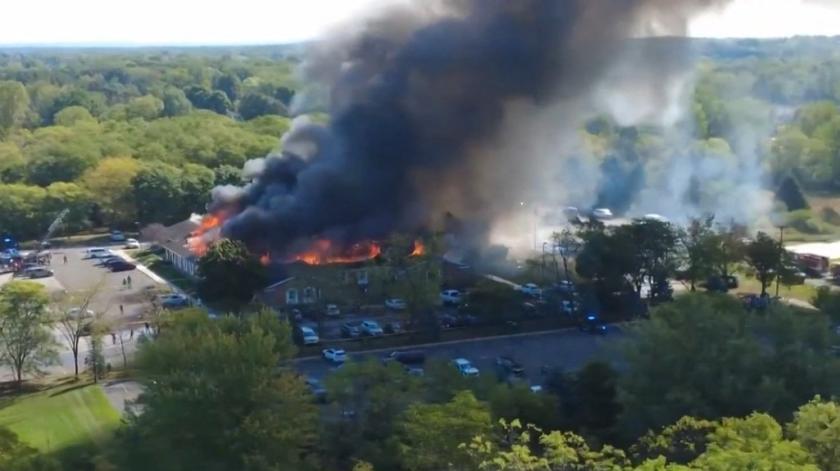 This frame grab from UGC drone footage obtained from "X/Julie J/@MALKOWSKI6APRIL" shows a fire at a Church of Jesus Christ of Latter-day Saints in Grand Blanc Township, Michigan on September 28, 2025. At least two people were killed and several others injured Sunday after a shooter targeted a Mormon church in Michigan, authorities said, in the latest deadly tragedy that US President Donald Trump called part of a national "epidemic of violence." The suspect, a 40-year-old man from a nearby town in the northe