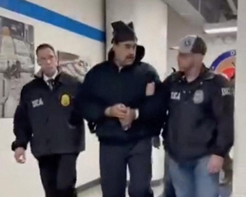 This screengrab taken from the X account of Rapid Response 47, the official White House rapid response account, shows Venezuelan President Nicolas Maduro (C) escorted by DEA agents inside the headquarters of the US Drug Enforcement Administration (DEA) in lower Manhattan, New York, on January 3, 2026. President Donald Trump said January 3 that the United States will "run" Venezuela and tap its huge oil reserves after seizing leftist leader Nicolas Maduro during a bombing raid on Caracas. Trump's announcemen