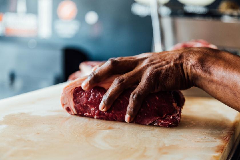 Foto: Unsplash Man houdt stuk vlees vast