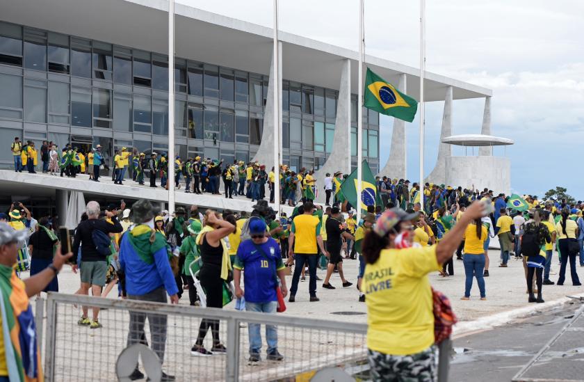 Supporters of Brazilian former President Jair Bolsonaro invade Planalto Presidential Palace in Brasilia on January 8, 2023. Hundreds of supporters of Brazil's far-right ex-president Jair Bolsonaro broke through police barricades and stormed into Congress, the presidential palace and the Supreme Court Sunday, in a dramatic protest against President Luiz Inacio Lula da Silva's inauguration last week. Ton MOLINA / AFP Supporters of Brazilian former President Jair Bolsonaro invade Planalto Presidential Palace in Brasilia on January 8, 2023. Hundreds of supporters of Brazil's far-right ex-president Jair Bolsonaro broke through police barricades and stormed into Congress, the presidential palace and the Supreme Court Sunday, in a dramatic protest against President Luiz Inacio Lula da Silva's inauguration last week. Ton MOLINA / AFP