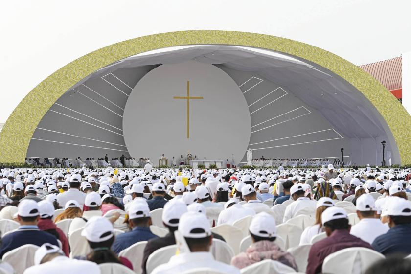 This handout photo released by the Vatican Media shows worshippers attending a mass held by Pope Francis at Bahrain National Stadium in Riffa, near the capital Manama, on November 5, 2022. About 30,000 flag-waving worshippers joined an open-air mass held by Pope Francis in mainly Muslim Bahrain, the highlight of his outreach mission to the Gulf. VATICAN MEDIA