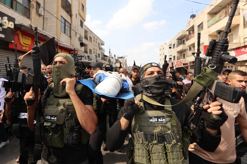 Palestinian militants carry the body of 19-year-old Ahmad Awawda who was killed in clashes with Israeli troops in the occupied West Bank region of Nablus the previous day, during his funeral in Jenin on October 8, 2023. Following the latest Hamas offensive and Israeli reprisals on the Gaza Strip, clashes flared on October 7 across the occupied West Bank leaving at least seven Palestinians dead, according to the health ministry in Ramallah. Zain JAAFAR / AFP Palestinian militants carry the body of 19-year-old Ahmad Awawda who was killed in clashes with Israeli troops in the occupied West Bank region of Nablus the previous day, during his funeral in Jenin on October 8, 2023. Following the latest Hamas offensive and Israeli reprisals on the Gaza Strip, clashes flared on October 7 across the occupied West Bank leaving at least seven Palestinians dead, according to the health ministry in Ramallah. Zain JAAFAR / AFP