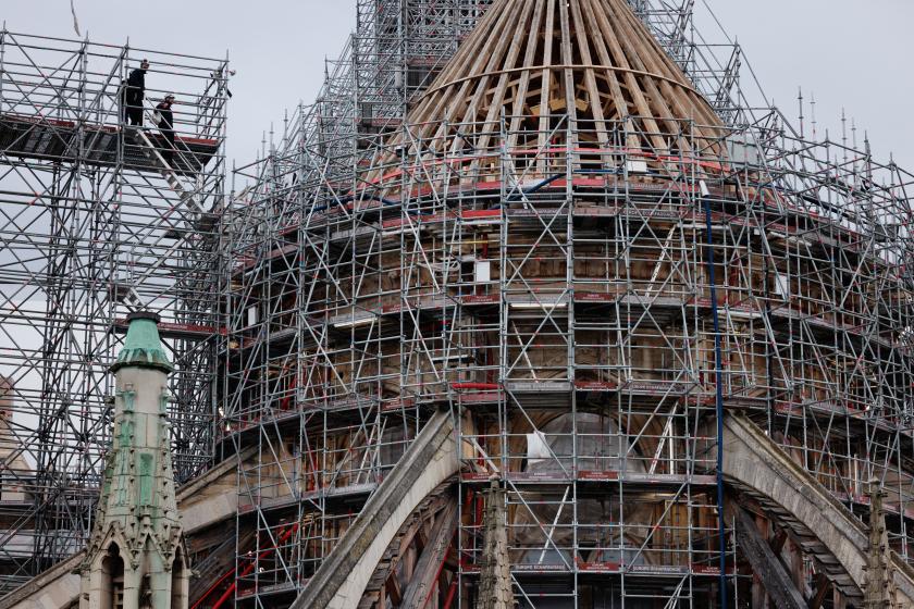 Workers operate on scaffoldings, during reconstruction work, around the wooden structure of the new spire in place at Notre-Dame de Paris Cathedral, on the Ile-de-la-Cite in Paris, on January 23, 2024. This spire is being reconstructed to be identical to the original one, destroyed in the fire of April 15, 2019 with the Cathedral set to be reopened at the end of 2024 according to the French Minsitry of Culture. JOEL SAGET / AFP Workers operate on scaffoldings, during reconstruction work, around the wooden structure of the new spire in place at Notre-Dame de Paris Cathedral, on the Ile-de-la-Cite in Paris, on January 23, 2024. This spire is being reconstructed to be identical to the original one, destroyed in the fire of April 15, 2019 with the Cathedral set to be reopened at the end of 2024 according to the French Minsitry of Culture. JOEL SAGET / AFP