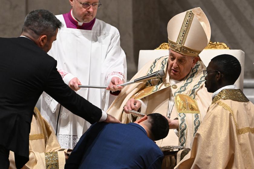 Pope Francis baptizes a man during the Easter vigil as part of the Holy Week celebrations, at St Peter's Basilica in the Vatican on March 30, 2024. Tiziana FABI / AFP