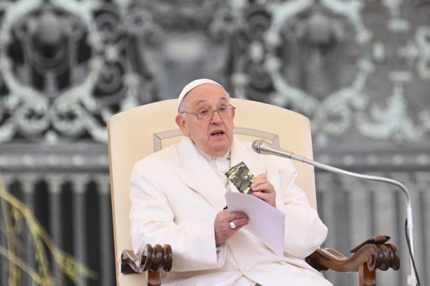 Pope Francis holds a small new Testament from a 23 year old soldier which died in Ukraine during his weekly general audience in St.Peter's square at the Vatican on April 3, 2024.  Alberto PIZZOLI / AFP