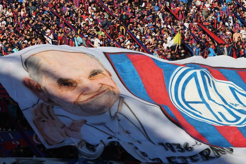 Fans of San Lorenzo display a giant banner depicting the late Pope Francis during the Argentine Professional Football League 2025 Apertura Tournament football match between San Lorenzo and Rosario Central at the Pedro Bidegain stadium in Buenos Aires on April 26, 2025. The late Pope Francis, Jorge Bergoglio, was a fan and member No. 88235 of Argentina's San Lorenzo football club. ALEJANDRO PAGNI / AFP