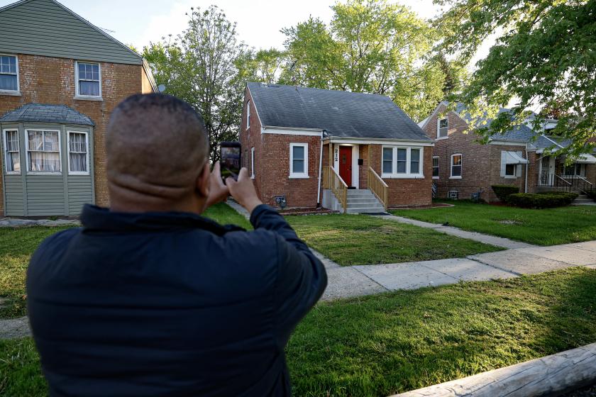 A person takes a picture of the childhood home of the new Pope Leo XIV in Dolton, Illinois, on May 9, 2025. Robert Francis Prevost became the first pope from the United States on May 8, 2025, picking the papal name Leo XIV after cardinals from around the world elected him leader of the world's 1.4 billion Catholics. Tens of thousands of people packed in St Peter's Square cheered as Prevost appeared on the balcony of St Peter's Basilica, waving with both hands, smiling and bowing. KAMIL KRZACZYNSKI / AFP