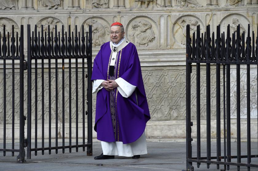 French Cardinal Andre Vingt-Trois stands in front of the Notre Dame Cathedral to lead a Mass to pay tribute to the priest Jacques Hamel, killed on July 26 in his church of Saint Etienne du Rouvray during a hostage-taking claimed by Islamic State group, in Paris on July 27, 2016. France probes an attack on a church in which two men described by the Islamic State group as its "soldiers" slit the throat of a priest. An elderly priest had his throat slit in a church in northern France on July 26 after two men s