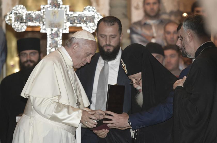 In this handout picture released by the Vatican Press office Pope Francis (L) receives a crucifix as a gift from Georgia's Orthodox Patriarch Ilia II during a visit at the Svetitskhoveli Cathedral in Mtskheta, on October 1, 2016 as part of his trip to Georgia and Azerbaijan. HO / OSSERVATORE ROMANO / AFP