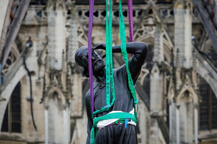 A crane lifts a statue of Saint-Thomas, the last one of the 16 giant copper-coated apostle statues, to be placed back atop the spire of Notre-Dame de Paris Cathedral in Paris on July 24, 2025. The statues, designed by Eugene Viollet-le-Duc and created by sculptor Adolphe Victor Geoffroy-Dechaume, had escaped the 2019 blaze at Notre-Dame, having been removed for renovation just days before the fire ravaged the cathedral. The statue bears the face of Eugene Viollet-le-Duc. GEOFFROY VAN DER HASSELT / AFP