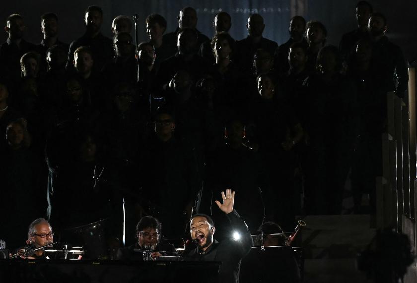 US singer-songwriter John Legend performs onstage during "Grace for the World" free concert and light show in Saint Peter's Square at the Vatican on September 13, 2025. "Grace for the World" concert is co-directed by American songwriter Pharrell Williams and Italian tenor Andrea Bocelli. The event marks the end of the third "World Meeting on Human Fraternity", a series of encounters launched after the 2020 publication of the "All Brothers" encyclical by the late pope Francis. Filippo MONTEFORTE / AFP