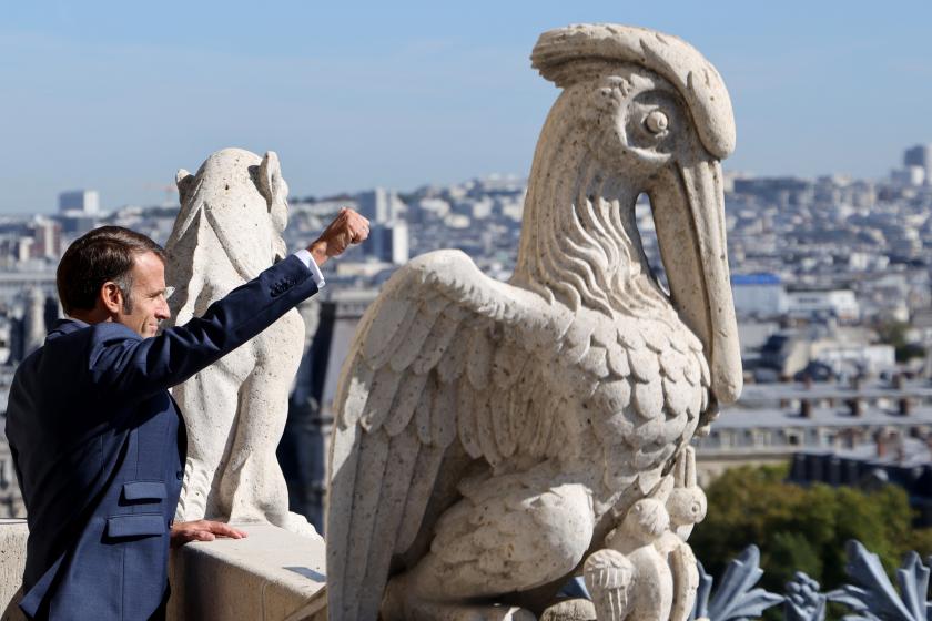 France's President Emmanuel Macron on top of the new Cathedral Towers Gothic structures destroyed following the April 2019 fire, as part of the 42nd edition of the European Heritage Days in Paris, on September 19, 2025. Ludovic MARIN / POOL / AFP