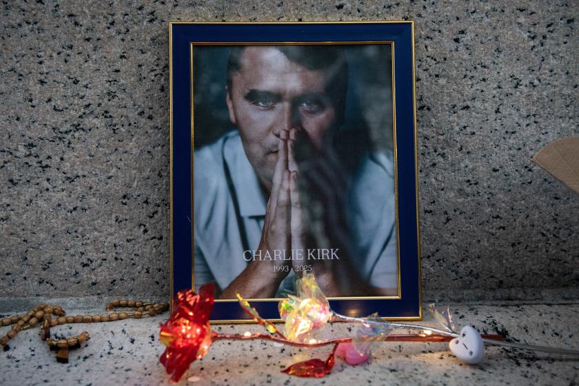 The reflection of a US flag appears in a portrait of Charlie Kirk during a vigil in his honor in Boston, Massachusetts, on September 18, 2025. Kirk, a close ally of President Donald Trump, was shot dead last week during a speaking event on a Utah university campus.  Joseph Prezioso / AFP