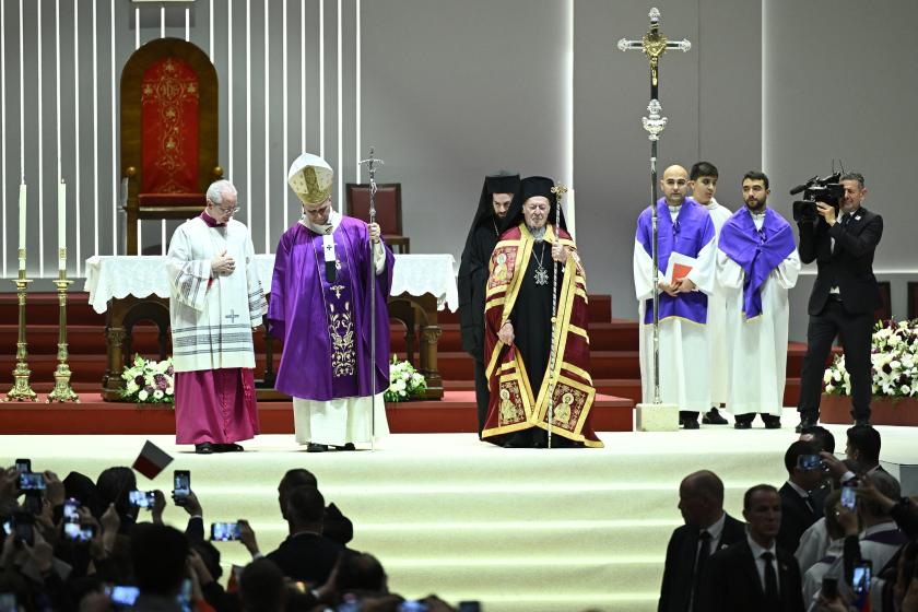 Patriarch Bartholomew I (C) attends a holy mass presided by Pope Leo XIV at the Volkswagen Arena as part of his apostolic journey to Turkey and Lebanon, in Istanbul on November 29, 2025.  YASIN AKGUL / AFP