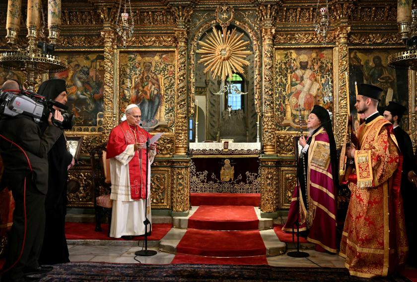 Pope Leo XIV (C-L) speaks next to Patriarch Bartholomew I (C-R) during the doxology at the Patriarchal Church of Saint George, in Istanbul on November 29, 2025.  OZAN KOSE / AFP