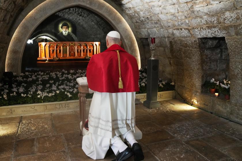 Pope Leo XIV prays in front of the tomb of Saint Charbel Makhlouf at the Monastery of Saint Maroun, in the mountainous village of Annaya on December 1, 2025.  Domenico Stinellis / POOL / AFP