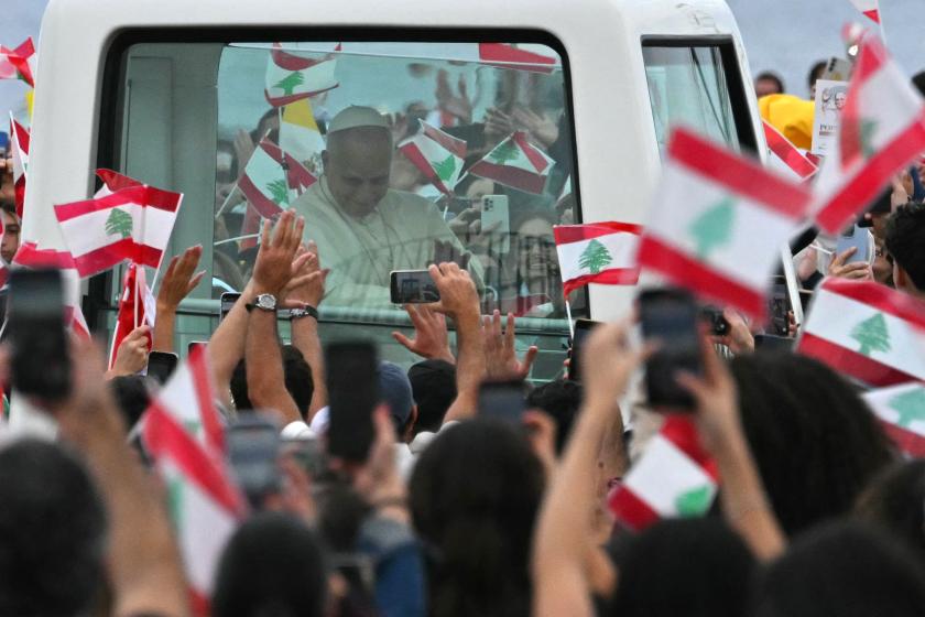 Pope Leo XIV waves to the crowd from the popemobile as he arrives for a mass at Beirut's waterfront, during his apostolic journey on December 2, 2025. Andreas SOLARO / AFP
