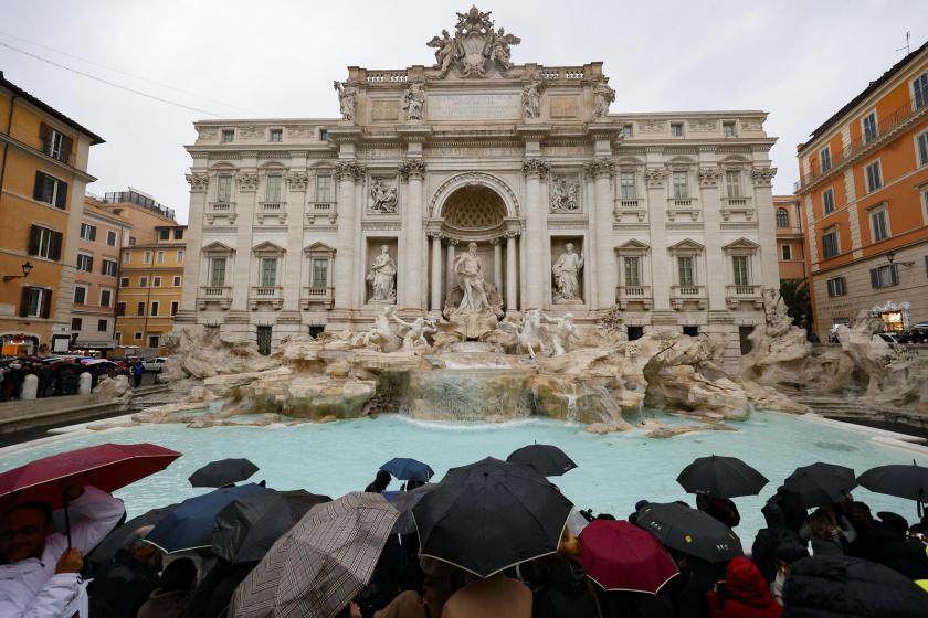 People look at the Trevi Fountain and take pictures as it reopens to the public after undergoing maintenance, in Rome, Italy, 22 December 2024. The 18th-century Fontana di Trevi has been cleaned ahead of the Vatican's Holy Jubilee of 2025. EPA/FABIO FRUSTACI