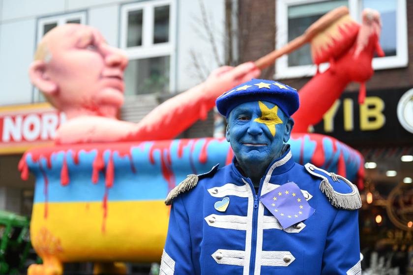 Artist Jacques Tilly poses in front of one of his carnival floats featuring Russia's President Vladimir Putin taking a blood bath in a Ukraine-designed bathtub during a Rose Monday street carnival parade in Duesseldorf, western Germany, on February 20, 2023.  INA FASSBENDER / AFP