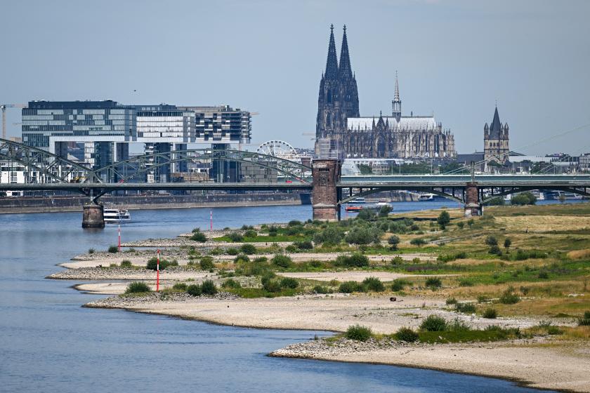 A photo shows the partially dried-up river bed of the Rhine with the Cologne cathedral in the background in Cologne, western Germany, on July 18, 2022 as many parts of Europe experience a heatwave. Europe's increasingly frequent heatwaves are back under the spotlight over devastating wildfires and with sweltering temperatures forecast to hit record highs in Britain and France this week. INA FASSBENDER / AFP