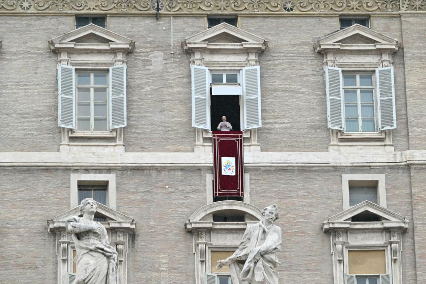 Pope Leo XIV addresses the crowd from the window of the apostolic palace overlooking St. Peter's square during the Angelus prayer in The Vatican on March 22, 2026. Alberto PIZZOLI / AFP