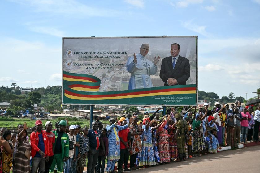 Children cheer as Pope Leo XIV's motorcade arrives ahead of a meeting with Cameroon's President Paul Biya at The Presidential Palace in Yaounde, on the third day of an 11-day apostolic journey to Africa, on April 15, 2026. Alberto PIZZOLI / AFP