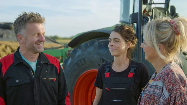 drie mensen voor een tractor