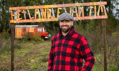 Man met rood-zwart geblokt overhemd in natuur