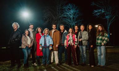 Groep acteurs geposeerd in het donker